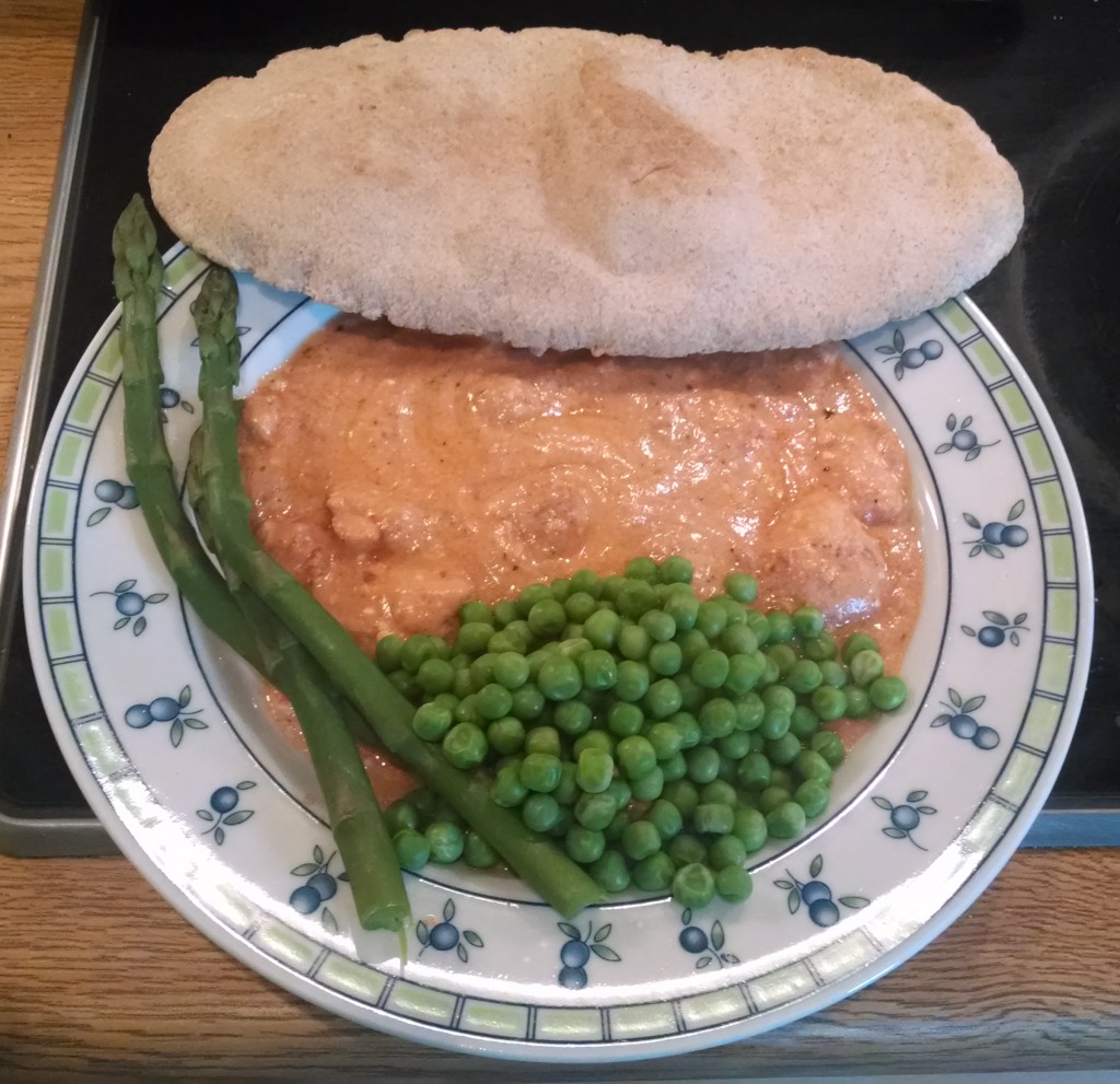 Chicken in tomato and Philadelphia sauce with asparagus, peas and pitta