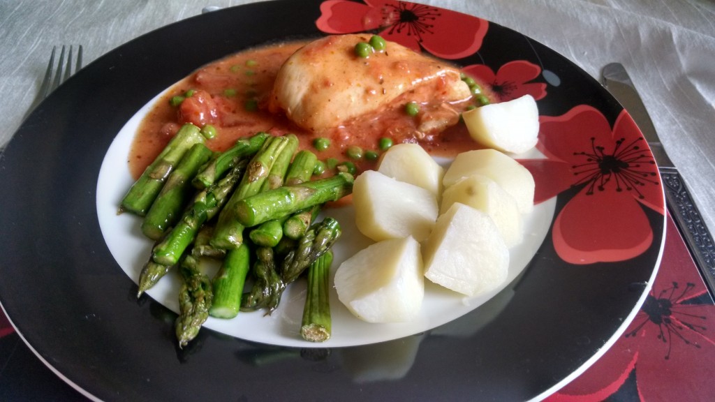 Chicken in tomato sauce with peas, asparagus and new potatoes