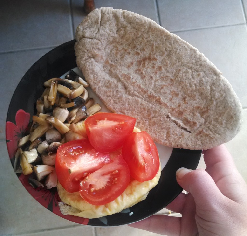 Breakfast of pitta, tomato, mushrooms and egg