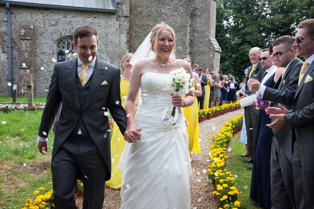 Throwing confetti at our wedding in Sharrington church