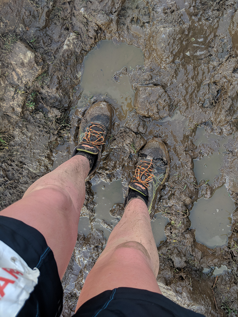 Mud at Every year my running club go to Gower for a long weekend in three beautiful cottages along the Gower coast with the intention of running the EnduranceLife Coastal Trail Series races held each November. One of the runners from our club has been organising the trip to Wales for the last seven years now. I made my first appearance with the group back in 2014. You can read about my previous Gower adventures in these recaps... >> 2014 recap * 2015 recap * (Oscar was only a few weeks old in 2016 so I didn't go that year) * 2017 recap The trip spans from the Friday afternoon through until Monday lunchtime, with car loads of runners arriving throughout the Friday and leaving across Sunday and Monday. As Oscar attends nursery on Fridays and Dan was able to take Monday off from work I was able to spend the whole four days hanging out with my friends and as much as I missed Oscar and Dan whilst I was away, it was so lovely to get away and just have a complete break with a bunch of like-minded people. It had started to rain as we reached the border to Wales (standard Welsh weather!) and was absolutely tipping it down by the time we were headed off to the pub for our Friday night meal and so, so windy. We could barely hear each other talk on the walk down and I instantly regretted bothering to straighten my hair when it became a knotty mess on arrival at the pub! Drinking in the pub at GowerNobody stayed up too late on the Friday night. This year the course had changed. Essentially, it was the same route for us marathoners, but starting and finishing at a different point in the course (about where mile 20 would usually fall, on the final beach). I've never run the half marathon route before but I'm told this had totally changed this year. The half marathoners had to register at the finish, but were then bussed back to start in a different location. We've been used to our cottages being within walking distance of the finish line in previous years and everybody stumbling back at different times at the end of their races. We thought that perhaps this year, with us all having to hang on to the end and then fighting out for hot showers at the same time might prove rather tricky! What I didn't plan on was waking up at 4:30am on race day with incredibly bad period cramps and a killer headache. Oh great, thanks for that body! I jumped into the van with a bunch of others from our club and we set off to the start line, about 10 miles away. Gower marathon start beachThe sun was only just beginning to surface and there were deep puddles across the car park from the rain the previous day. The beach itself was tough moving on and my back was killing already! Gower marathon start beachI was livid to discover there was no Clif bar in my starter pack! The price of the race had gone up by £10 this year (to £60) and we didn't even get a Clif bar at the start, just a Tribe bar. I was gutted. It was really turning out to not be my day!Tribe bar at EnduranceLife Gower marathonThey even had a Clif banner just outside to rub it in a little more! Clif Bar banner at EnduranceLife Gower marathonAfter taking a quick photo by the starting flags we raced back to the van for half an hour as the rain began to come again, and hard! Gower marathon start beachLuckily it had slowed somewhat by the time we emerged for the end of the briefing and to shelter in the tent until we were summoned for the start. Gower marathon start beachFull wet weather gear required! We set off as a group from the back - five of us. A few miles in we saw a teenager come off a quad bike out on the track. He spun to a stop and flipped right off the top. Seemed OK though. Got up and sped back off again. We started chatting to another runner, who I later came across on Instagram when scrolling the #gowermarathon hashtag. View this post on Instagram Gower marathon report part 2 - After getting through the dunes it was a climb up onto the hills and a wonderful walk along the ridge. These wonderful people kept me going up as we played cat and mouse all the way up although eventually 2 of them did over take, never to be seen again. Once i got to the top and was running to the top I realised I was actually really enjoying myself, i did not think this would happen. We finally made it to check point one. The first of 4 to be ticked off. My timing was a bit slow but it was down hill from here to check point 2. The sun was shinning what could possibly go wrong 💪💪💪 . . #marathon #marathontraining #trustthetraining #trusttheprocess #womenwhorun #runningcommunity #runningclub #racereport #thisgirlcan #thisgirlcanrun #thisisstrong #youmatter #selflove #strongisnotasize #believe #rainyraceday #imasurvivor A post shared by Eleanor 🇬🇧 (@iron_woman98) on Nov 11, 2018 at 5:03am PST Not long after that first checkpoint I carried on along with Guy, leaving the others to run at their pace, knowing that I would get cold if I didn't continue to move. It wasn't long before I came across another runner who I fell instep with for several miles. We ran across the long beach together, overshooting the cut through as the marshals had left up the half marathon route directions further along the beach. EnduranceLife Gower marathon beach I always find beach running hard. Not only is it tough going underfoot, but it's mentally tough for the scenery to be exactly the same stretching off into the distance. It did feel much easier going round the course in this direction on the beaches though for some reason, despite the wind being against us for most of the way. There was another checkpoint just after the beach. I didn't need to take anything on board so just checked in and carried on, losing the runner I had spent the last few miles with as he topped up on fluids and snacks here. The next hill was the toughest of all. It used to fall about 6 miles into the original marathon course (in the other direction) and was always the trickiest part to navigate down. There is a spring which appears in the middle of this hill, making the going underfoot very slippy as a lot of the ground is covered in small rocks with little to get any grip on. One of our runners has been down on his bum every year he's entered this race and I've been very close each time! EnduranceLife Gower marathonThis year though, we were to make our way up the hill instead, along the already-worn muddy track. EnduranceLife Gower marathonIt's really quite steep in places and it was raining again by now. EnduranceLife Gower marathon